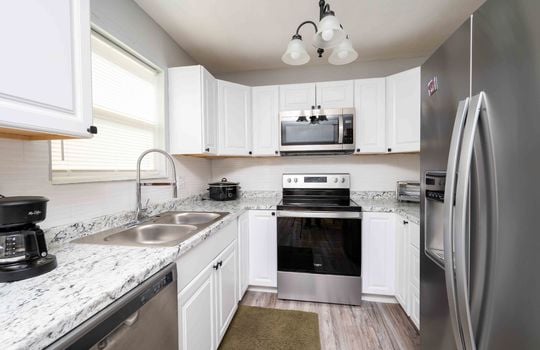 kitchen, white cabinets, stainless appliances, dishwasher, stove, refrigerator, sink, built in microwave, counters
