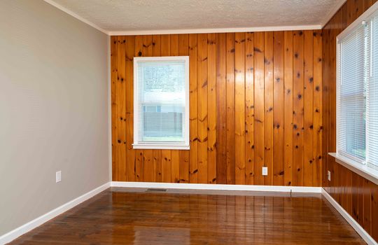 wood paneled wall, hardwood flooring, large window