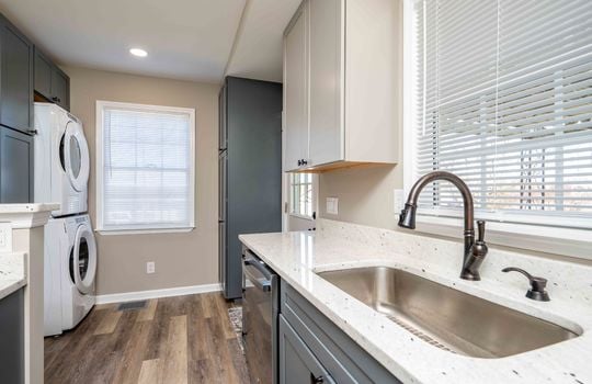 kitchen, laundry area, sink, granite countertops, back door, windows