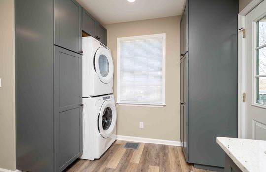 built in laundry area, cabinets, back door