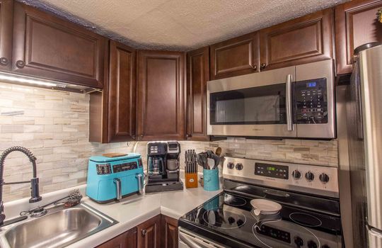 kitchen, sink, stove, corner cabinets, built in microwave