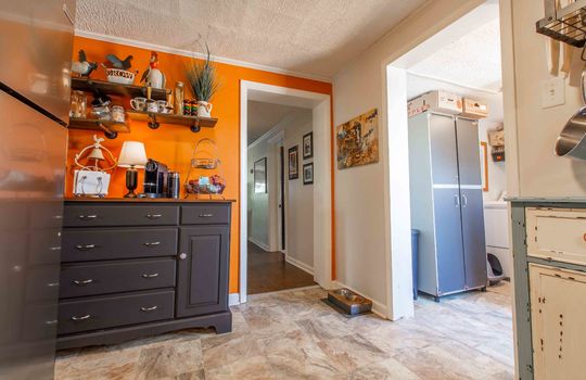 refrigerator, vinyl flooring, hallway, dining area