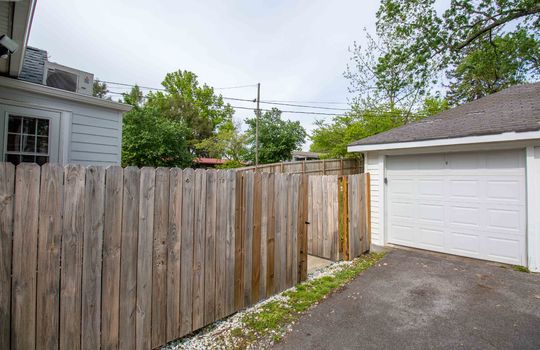 one car garage, gate to fenced back yard