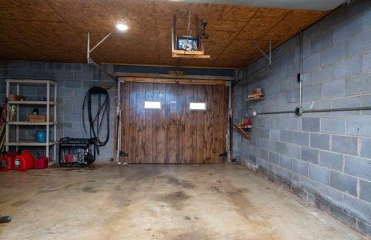 garage, garage door, concrete flooring, block walls