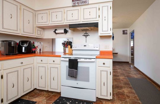 kitchen, cabinets, stove, vinyl flooring