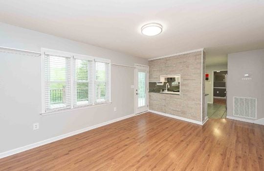 open downstairs living space, hardwood flooring, exterior door