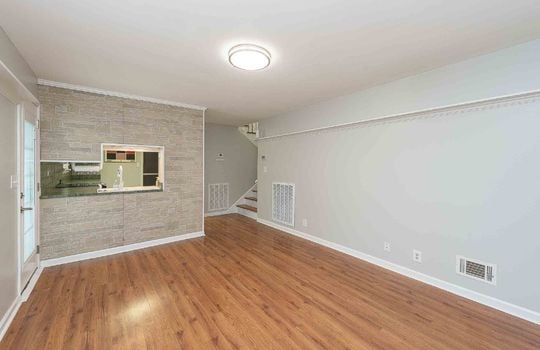 open downstairs living space, hardwood flooring, exterior door