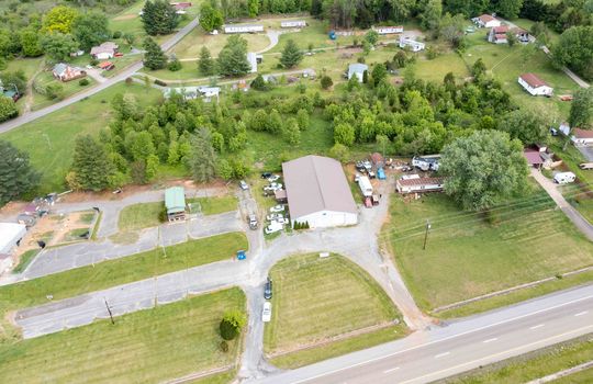 Aerial view from road, circle driveway, gravel driveway, parking lot, commercial building