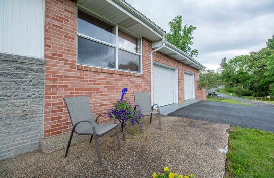Front porch, concrete, driveway, garage doors