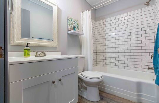 bathroom, toilet, sink, tub/shower, tile shower, shaker cabinet