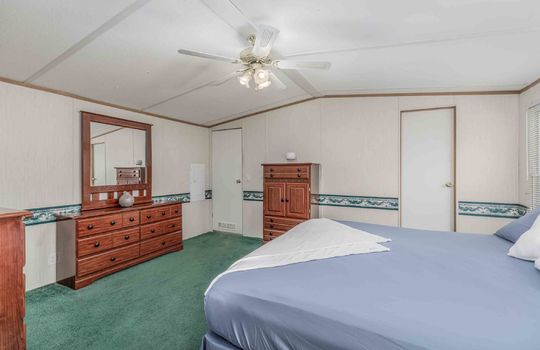 primary bedroom, king bed, carpet, ceiling fan, door, closet