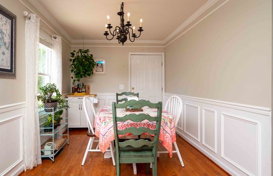 dining room, chandelier, wainscoting, hardwood flooring