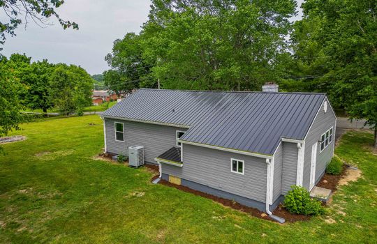 aerial view, 1 story home, metal roof, vinyl siding