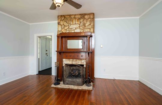 living room, hardwood flooring, fireplace, ceiling fan