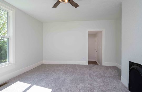 primary bedroom, carpet, ceiling fan, door