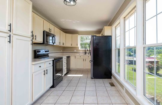kitchen, tile flooring, microwave, stove, dishwasher, refrigerator, sink, window