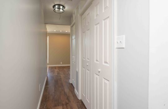hallway, hardwood flooring, closets