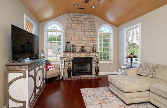 condo, living room, cherry hardwood flooring, arched windows, brick fireplace, wood ceiling