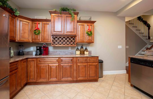 kitchen, tile flooring, cabinet, granite counters, built-in wine rack, dishwasher, refrigerator