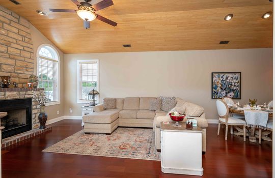 condo, living room, cherry hardwood flooring, arched windows, brick fireplace, wood ceiling