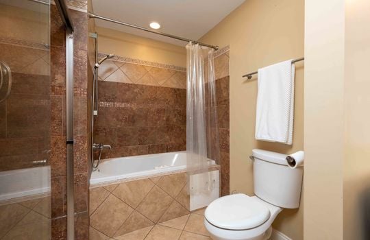 bathroom, toilet, shower, tile flooring, tile surround