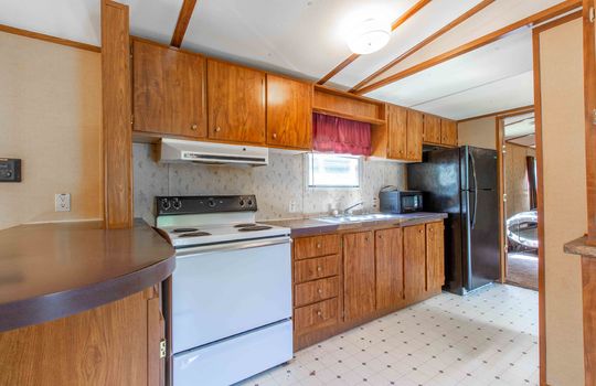 kitchen, cabinets, stove, sink, refrigerator, vinyl flooring