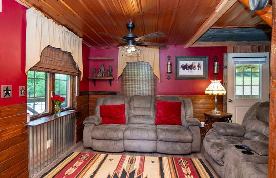 living room, laminate flooring, window, wood ceiling, door to back deck
