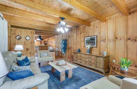 living room, wood walls, wood ceiling, ceiling fan, windows