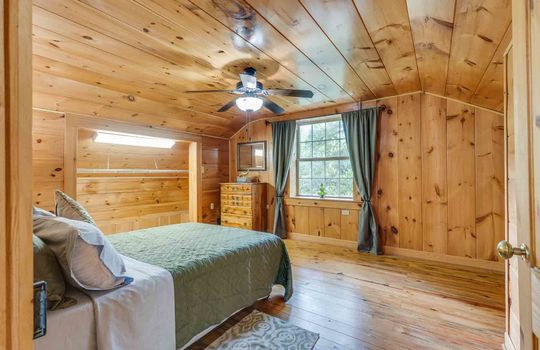 bedroom, wood walls, wood flooring, ceiling fan, window