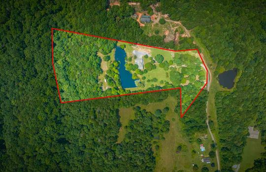 aerial view of property, cabin, pond, trees, outline of property
