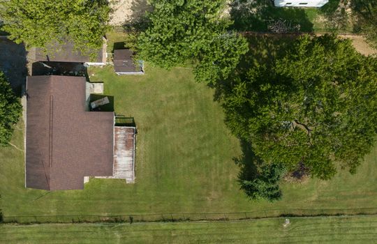 aerial view of property, yard, trees