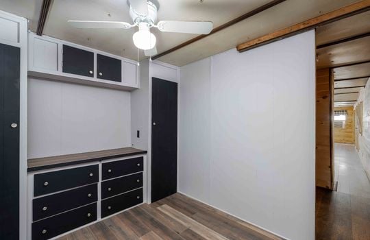 primary bedroom, built in storage, ceiling fan, laminate flooring