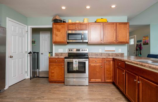 kitchen, cabinets, laminate countertops, built-in microwave, stove/oven, laminate flooring