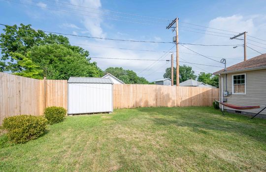back yard, landscaping, privacy fence, trees, storage shed