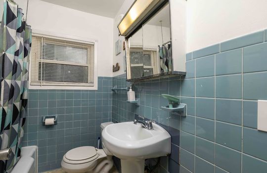 bathroom, tub/shower, toilet, sink, medicine cabinet, tile walls