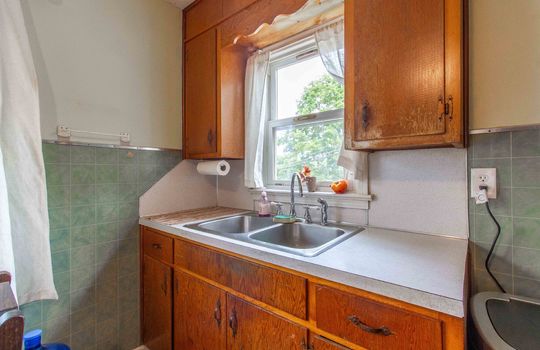 window over kitchen sink, cabinet, counter
