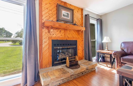 wood fireplace mantle, stone hearth, windows, living room, laminate flooring