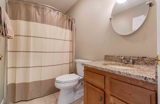 bathroom, vinyl flooring, granite countertop, sink, toilet, shower/tub