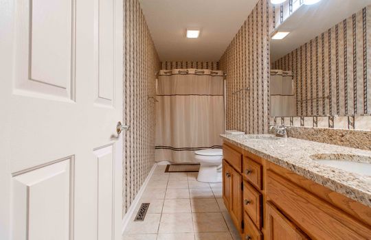 bathroom, granite countertops, cabinet, sink, toilet, tile flooring, tub/shower