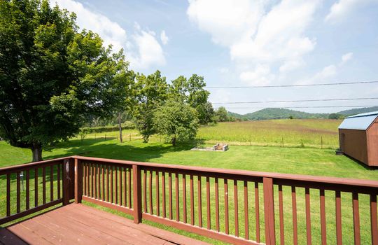 back deck, deck railing, back yard, mountains, shed, trees