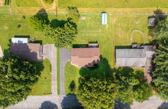 overhead aerial view of home, roof, yard, trees, shed, driveway
