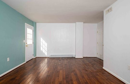 living room, front door, laminate flooring, baseboard heating