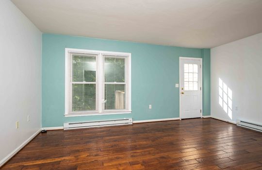 living room, front door, laminate flooring, baseboard heating