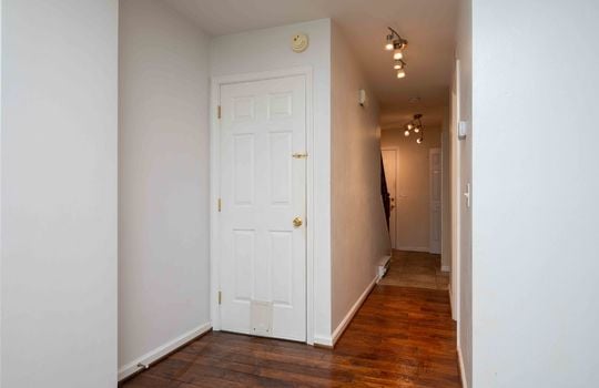 hallway, closet, laminate flooring, ceramic tile flooring