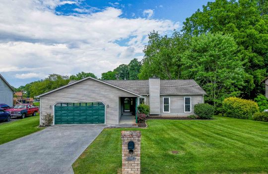 One story home, vinyl siding, front yard, brick mailbox, driveway, garage, front door, trees
