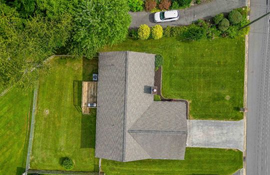 aerial view of property, roof, driveway, back yard, back deck