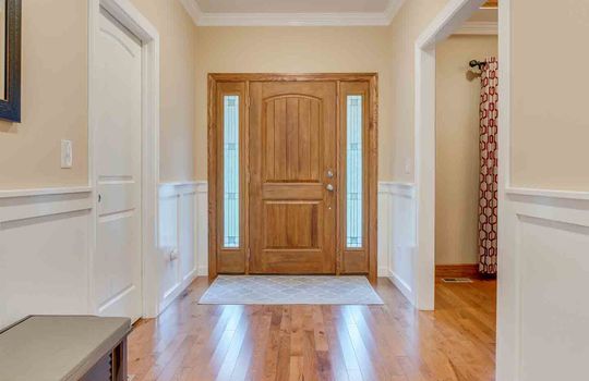 foyer, entryway view toward front door, hardwood flooring