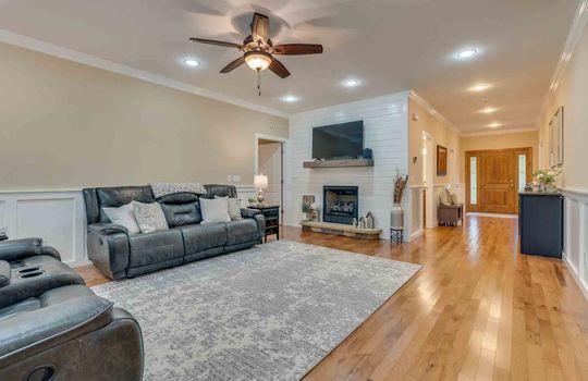 living room, hardwood flooring, ceiling fan, recessed lighting, fireplace