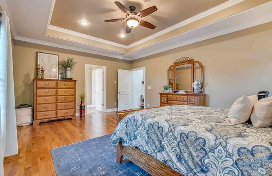 bedroom, hardwood flooring, tray ceiling, recessed lighting, ceiling fan