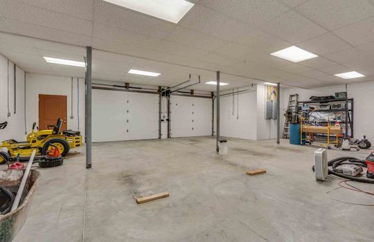 garage, garage doors, concrete flooring, two car garage